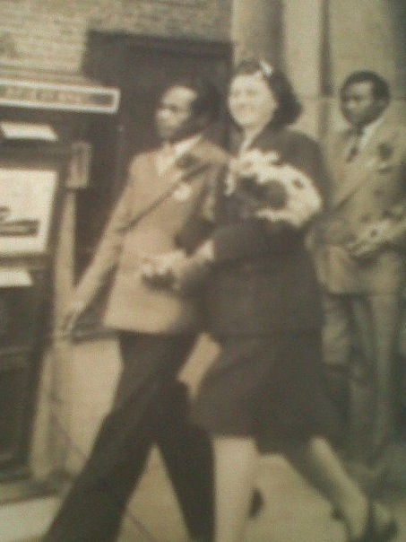 Trouwfoto Betsy en Djoemiran voor het stadhuis in Amsterdam, mei 1946